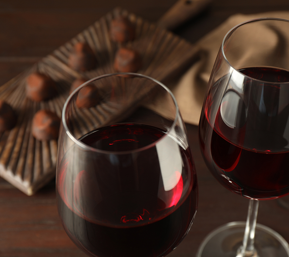 Two glasses of red wine with chocolate. Organic vegan chocolate and wine tasting.